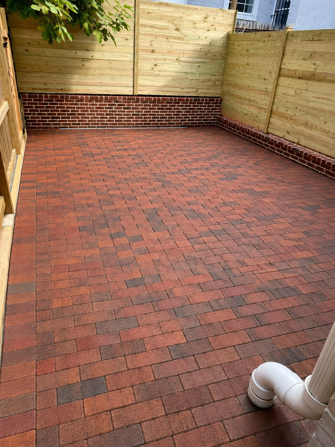 Brick courtyard patio with wood fencing