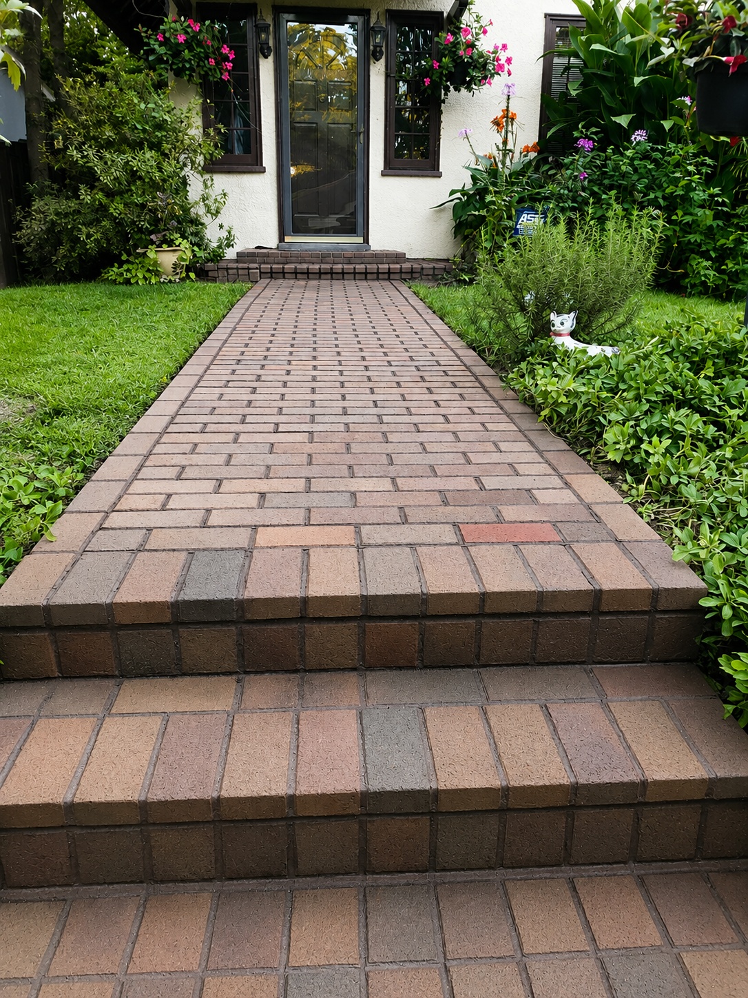 Brick walkway leading to a home entrance