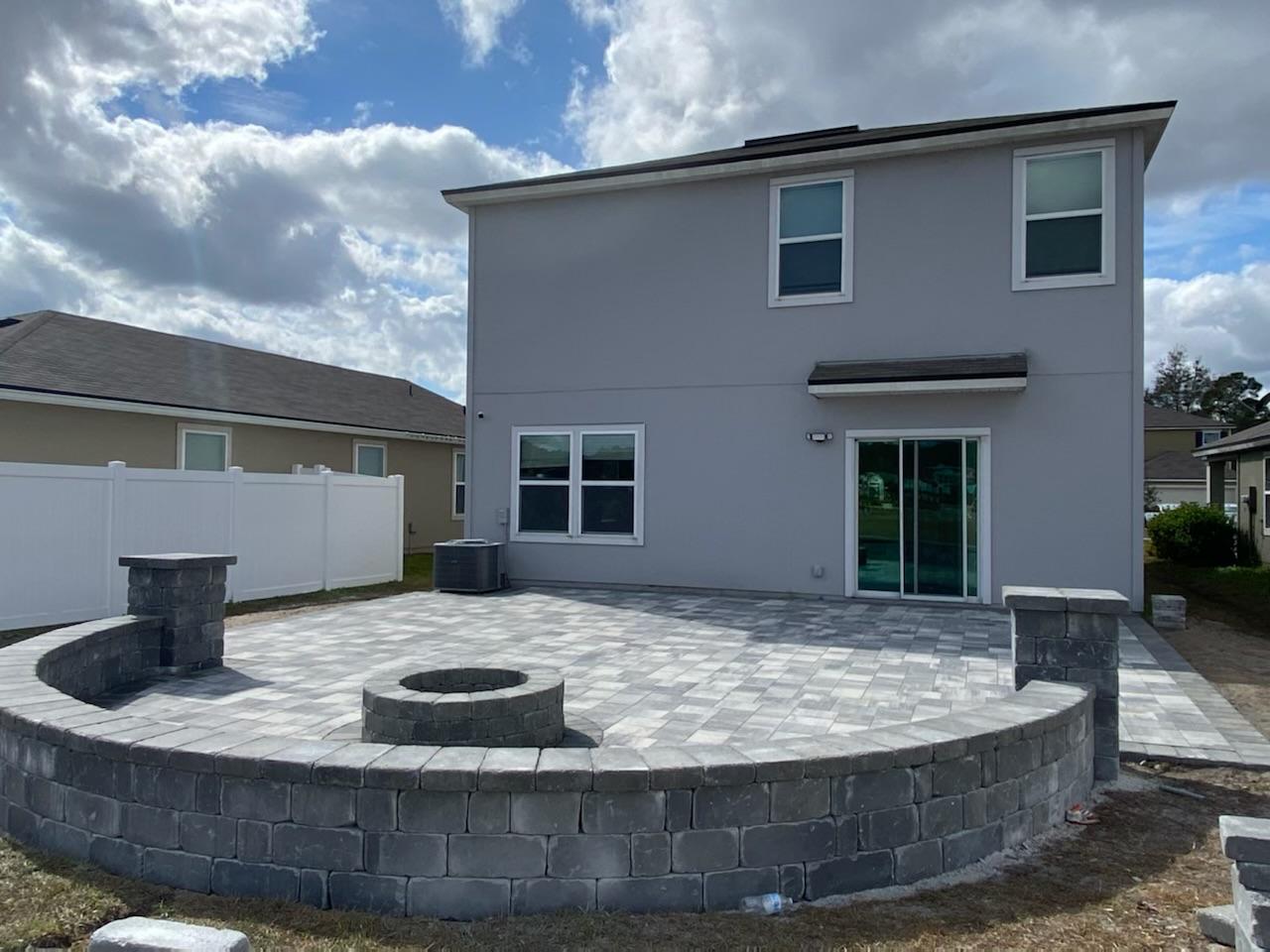 Finished stone patio with firepit and seating