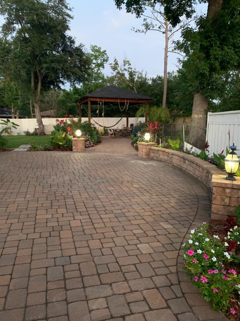 Finished stone patio built by Flores Landscaping