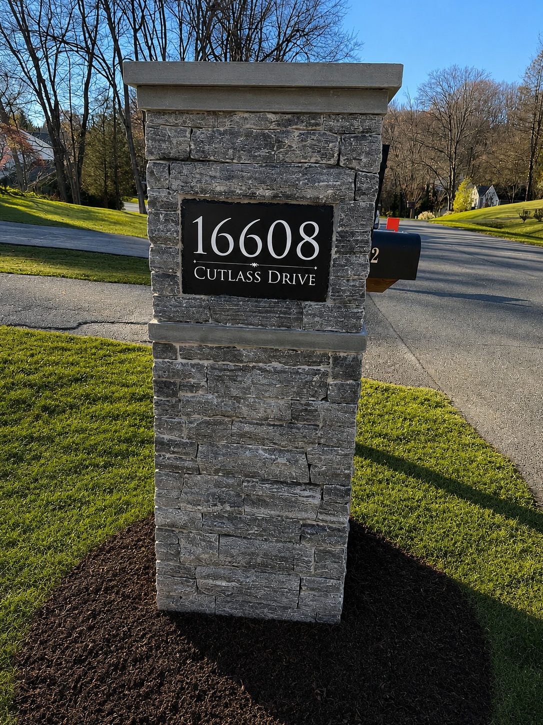 Custom stone mailbox with address sign built by Flores Landscaping